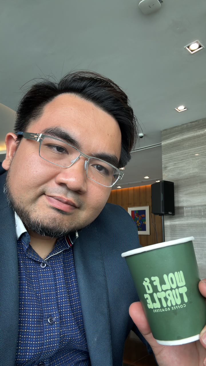 Syazwan with a Wolf & Turtle coffee before the day's first stand-up